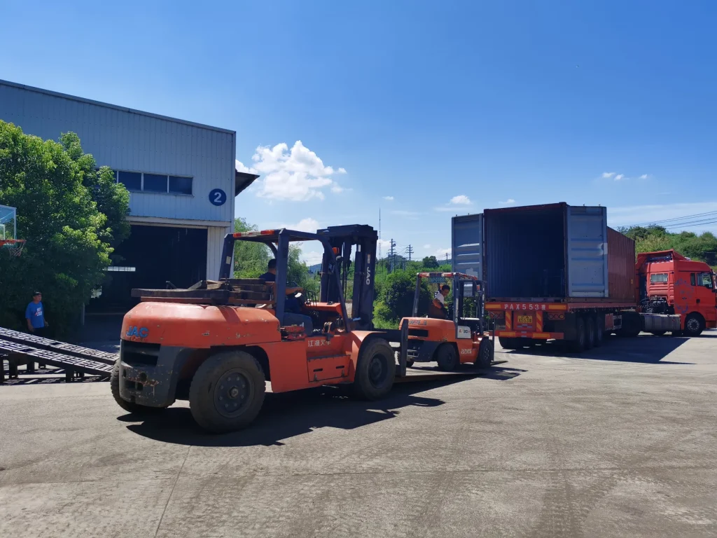Forklifts and shipping containers in the factory dispatch area