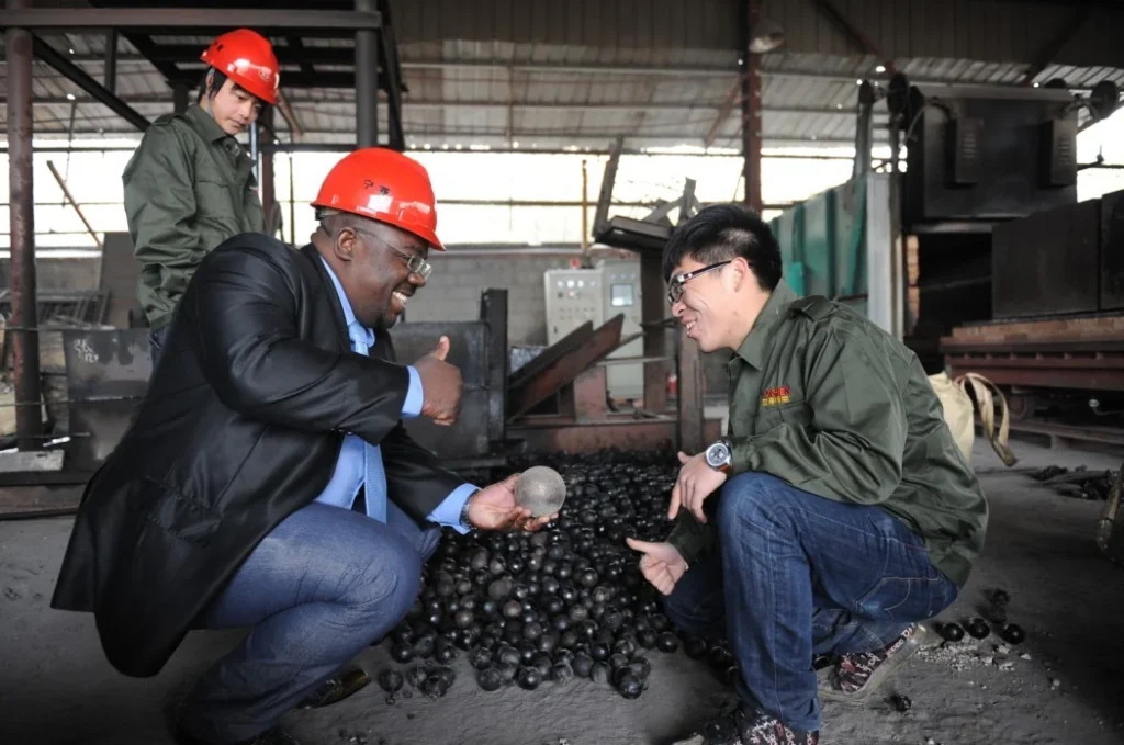 Factory-floor discussion with visiting customers